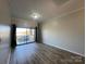 Bright, spacious living room with wood floors and balcony access offers scenic views at 715 N Church St # 301, Charlotte, NC 28202