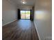 Bright living room features sleek wood floors and a balcony offering outdoor views at 715 N Church St # 301, Charlotte, NC 28202