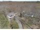 Aerial view showcasing home, detached garage with multiple cars, and a long winding driveway at 7218 Alexander Farm Rd, Monroe, NC 28110