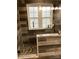 Bathroom with glass shower, stone pebble floor, wood-look tile and window at 7218 Alexander Farm Rd, Monroe, NC 28110