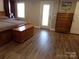 Comfortable bedroom with a queen-sized bed, wood floors, natural light and matching furniture at 7218 Alexander Farm Rd, Monroe, NC 28110