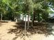 View of the side of the house and detached garage, fenced yard and mature trees at 7218 Alexander Farm Rd, Monroe, NC 28110