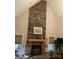 Living area with a floor-to-ceiling stone fireplace and a decorative wooden mantle at 7218 Alexander Farm Rd, Monroe, NC 28110