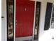 A red front door with black trim and decorative glass at 7218 Alexander Farm Rd, Monroe, NC 28110