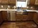 A kitchen sink with stainless steel appliances and wooden cabinets at 7218 Alexander Farm Rd, Monroe, NC 28110