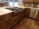 A kitchen island cooktop with granite countertop and wooden cabinets at 7218 Alexander Farm Rd, Monroe, NC 28110