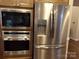 Kitchen featuring stainless steel appliances, including a refrigerator and built-in oven and microwave, showcasing modern amenities at 7218 Alexander Farm Rd, Monroe, NC 28110