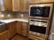 The kitchen features granite countertops and modern, stainless steel appliances at 7218 Alexander Farm Rd, Monroe, NC 28110