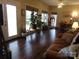 Living room features wood flooring, windows, house plants, and furniture at 7218 Alexander Farm Rd, Monroe, NC 28110