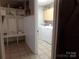 Hallway featuring built-in storage and a washer and dryer at 7218 Alexander Farm Rd, Monroe, NC 28110