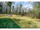 Backyard featuring green space, mature trees, and a storage shed at 724 Rocky River W Rd, Charlotte, NC 28213