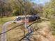Brick ranch-style home with a long driveway and mature trees in a wooded setting at 724 Rocky River W Rd, Charlotte, NC 28213