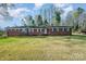 Charming brick home with a lush front lawn and classic white trim at 724 Rocky River W Rd, Charlotte, NC 28213
