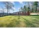 Single-story red brick house on a spacious lot with mature trees at 724 Rocky River W Rd, Charlotte, NC 28213