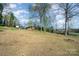Spacious yard with storage buildings, carports, and convenient street access at 724 Rocky River W Rd, Charlotte, NC 28213