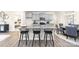 Bright kitchen boasts a large island with barstool seating, light gray cabinetry, and modern finishes at 7869 Iron Rd, Sherrills Ford, NC 28673
