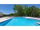 Expansive community swimming pool with clear blue water, surrounded by lounge chairs and lush greenery, with clear blue skies at 7869 Iron Rd, Sherrills Ford, NC 28673