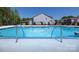 Community swimming pool showcasing stainless steel ladders, blue tiling, and lounge seating at 7869 Iron Rd, Sherrills Ford, NC 28673