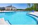 Large community pool featuring crystal clear water, a nearby clubhouse, and lounge chairs under a sunny sky at 7869 Iron Rd, Sherrills Ford, NC 28673