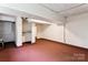 Unfinished basement space with concrete walls and floors, with visible pipes and support beams at 813 North Ave, Charlotte, NC 28208