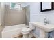 Classic bathroom with tiled shower, pedestal sink, and neutral color scheme, offering a timeless appeal at 813 North Ave, Charlotte, NC 28208