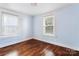 Bedroom with hardwood floors and light blue walls, offering a cozy and serene atmosphere at 813 North Ave, Charlotte, NC 28208