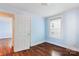 Bright bedroom with hardwood floors, featuring a door leading to another room at 813 North Ave, Charlotte, NC 28208