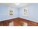 Bedroom featuring windows allowing ample natural light, complemented by hardwood floors at 813 North Ave, Charlotte, NC 28208