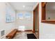 Welcoming entryway with natural light, a wooden bench, and stylish tile flooring at 813 North Ave, Charlotte, NC 28208