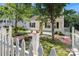 Charming home surrounded by lush trees and a picket fence, creating a serene curb appeal at 813 North Ave, Charlotte, NC 28208