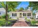 Charming single-story home with a well-manicured lawn, brick pathway, and welcoming front door at 813 North Ave, Charlotte, NC 28208