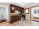 Functional kitchen featuring dark wood cabinetry, a double sink, and views to the next room at 813 North Ave, Charlotte, NC 28208