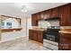 Galley kitchen featuring dark wood cabinets and modern appliances, perfect for cooking enthusiasts at 813 North Ave, Charlotte, NC 28208