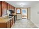 Functional kitchen featuring dark wood cabinetry, a double sink, and views to the next room at 813 North Ave, Charlotte, NC 28208