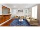 Stylishly furnished living room with hardwood floors, a fireplace, and bar serving area at 813 North Ave, Charlotte, NC 28208