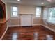 Cozy living room featuring hardwood floors, a fireplace, and bright windows at 813 North Ave, Charlotte, NC 28208