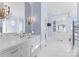 Luxurious bathroom featuring double vanity, marble countertops, and decorative mirrors at 8228 Bay Pointe Dr, Denver, NC 28037