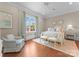 Bright bedroom with hardwood floors, window with a view, and a cozy reading chair at 8228 Bay Pointe Dr, Denver, NC 28037