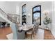 Formal dining room boasts soaring ceilings, ornate wrought iron windows, hardwood floors, and stylish decor at 8228 Bay Pointe Dr, Denver, NC 28037