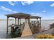 This lakefront home includes a private covered dock with bench seating and a boat lift, perfect for enjoying waterfront living at 8228 Bay Pointe Dr, Denver, NC 28037