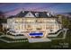 A spacious, luxurious home boasting meticulous landscaping, a multi-tiered patio, and a dazzling pool with a water feature at 8228 Bay Pointe Dr, Denver, NC 28037