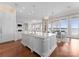 Open-concept kitchen with marble island, high-end appliances, and an adjacent dining area with waterfront views at 8228 Bay Pointe Dr, Denver, NC 28037