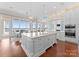 Open kitchen with island, marble countertops, and views overlooking the water and dining area at 8228 Bay Pointe Dr, Denver, NC 28037