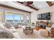 Living room with water views, wood beams, a large sofa, and a decorative fireplace at 8228 Bay Pointe Dr, Denver, NC 28037