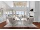 Bright living room featuring high ceilings, large windows with lake views, and elegant neutral decor at 8228 Bay Pointe Dr, Denver, NC 28037