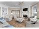 Bright living room with fireplace, white trim, area rug, and comfortable seating arrangement at 8228 Bay Pointe Dr, Denver, NC 28037