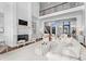 Elegant living room with a fireplace, built-in shelving, soaring ceilings, and large windows for ample natural light at 8228 Bay Pointe Dr, Denver, NC 28037