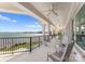 Covered patio overlooking the water with white columns, lounge furniture, and a grassy yard at 8228 Bay Pointe Dr, Denver, NC 28037