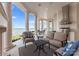 Covered patio featuring an outdoor kitchen, comfortable seating, and picturesque water views at 8228 Bay Pointe Dr, Denver, NC 28037