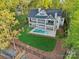 Aerial view of home with a private backyard pool, manicured lawn, and mature trees at 8813 Graham Rd, Denver, NC 28037